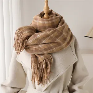 Detailed view of brown plaid cashmere-feel winter scarf with elegant fringe design.