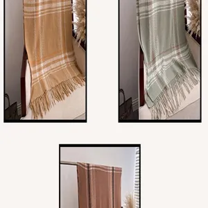 Detail view of cozy plaid tassel cashmere-feel scarf shawl, multi-color winter warm accessory.