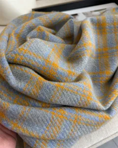 Close-up detail of soft imitation cashmere plaid scarf showing rich texture and autumn style.