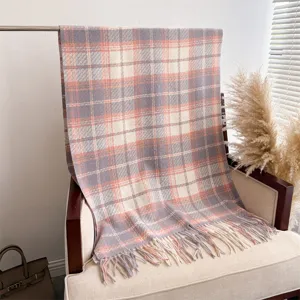 Cozy plaid tassel scarf detail shot, showing soft cashmere-feel fabric texture and chic fringe.