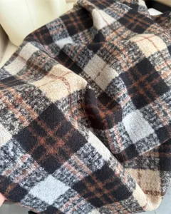 Close-up detail of Korean style plaid imitation cashmere winter warm scarf fabric texture.