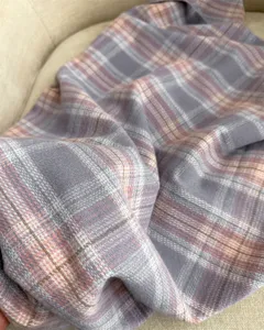 Detailed close-up view of the soft plaid imitation cashmere scarf for cozy winter warmth.