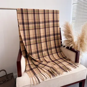 Detailed shot of classic plaid imitation cashmere scarf with fringe, warm and stylish autumn winter.