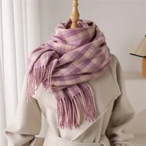 Close-up of a retro purple plaid winter scarf with delicate tassels, styled on a mannequin.