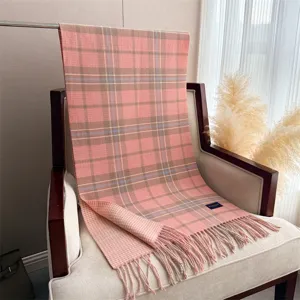 Elegant pink plaid imitation cashmere scarf with tassel design for autumn and winter warmth.