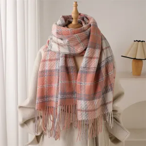 Detailed view of the cozy pink plaid fringe scarf, soft boucle cashmere texture for autumn winter.