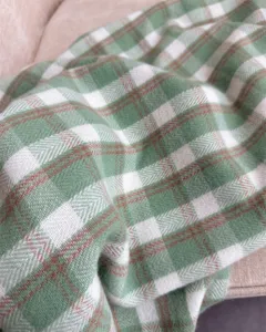 Green plaid cashmere-feel scarf detail, soft woven texture for cozy autumn winter style.