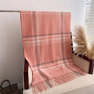 Pink plaid cashmere-feel winter scarf with tassels, cozy and stylish shawl for cold weather.