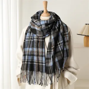 Detail view of the cozy blue plaid cashmere-feel scarf with fringe, perfect winter style.