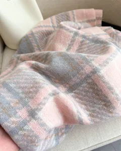 Detailed view of soft pink grey plaid loop yarn cashmere feel winter scarf and shawl detail.