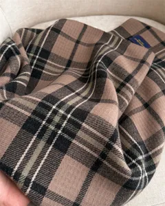 Classic plaid imitation cashmere scarf detail, soft texture and elegant winter accessory.