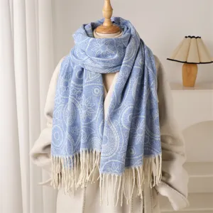 Blue paisley patterned winter cashmere feel scarf detail view with elegant tassel fringe design.