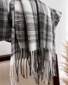Classic black and white plaid fringed scarf, detailed view showcasing soft texture.