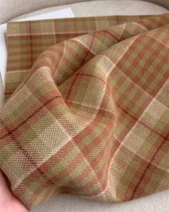 Detailed close-up view showing the soft plaid texture of the winter cashmere-feel scarf fabric.