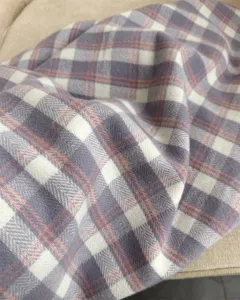 Close up detail of retro plaid imitation cashmere scarf showing soft texture and cozy fabric.