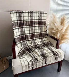 Plaid tassel scarf detail showing soft cashmere-like texture and cozy autumn winter styling.