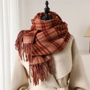Detail shot of a cozy autumn winter plaid imitation cashmere scarf with elegant fringe trim.
