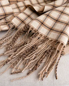 Close-up detail shot of classic plaid pattern fine cashmere-feel tassel scarf winter warm.