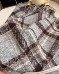 Detailed view of winter plaid imitation cashmere scarf with fringe, soft texture warm cozy.