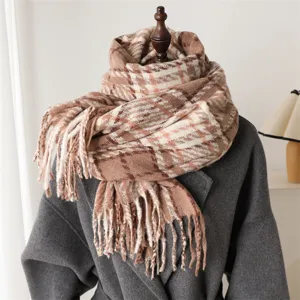 Detail shot of the cozy plaid winter scarf with chic fringe, soft texture and warm drape style.