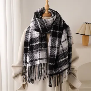 Close-up detail of the black and white plaid tassel scarf, soft winter texture display.