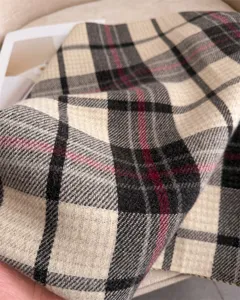 Detailed view of classic plaid pattern cashmere feel winter scarf fabric texture and soft finish.