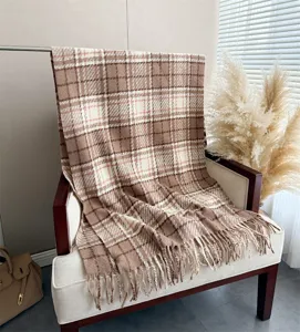 Cozy brown plaid boucle cashmere-feel scarf detail showcasing soft tassel edge and warm texture.