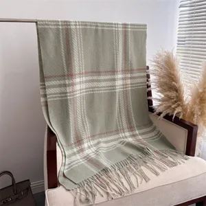 Detailed view of the cozy green plaid winter tassel scarf, soft texture for warm styling.