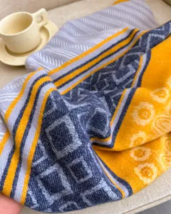 Autumn winter plaid cashmere feel scarf detail shot, cozy geometric pattern warm neckerchief.