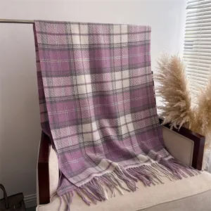 Detail view of a cozy Korean style plaid boucle cashmere-feel shawl with fringe for winter.