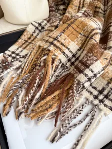 Close-up detail of winter warm plaid fringe scarf, soft loop yarn texture, cozy autumn accessory.