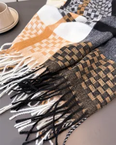 Close-up detail of cozy plaid fringed winter scarf texture and soft fabric design showcase.