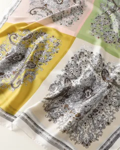 Close-up detail of vintage color-block paisley printed silk scarf, soft and smooth satin fabric.