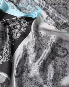 Close-up detail of retro color-block paisley print silk satin scarf fabric and texture.