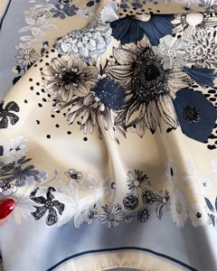 Detailed view of the elegant floral print silk square scarf, showing smooth silky texture.