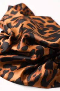 Elegant leopard print silk scarf, soft draped fashion shawl for women and versatile headwear.