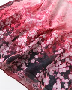 Detailed close-up view of a gradient floral print lightweight silk scarf and sun protection shawl.
