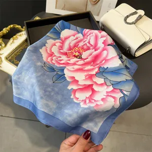 Blue silk square scarf featuring a large pink peony flower print, elegant neckerchief style.