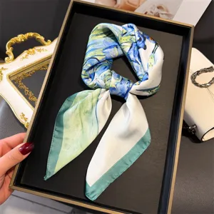 Detailed close-up shot of the blue floral silk scarf displayed neatly on a luxury black tray.
