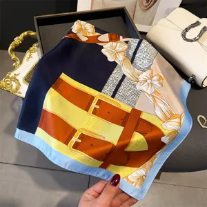 Elegant silk scarf with classic equestrian belt and bow print, stylish accessory for women.