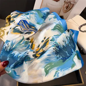 Blue and green abstract floral print silk scarf detail, elegant neck accessory close-up