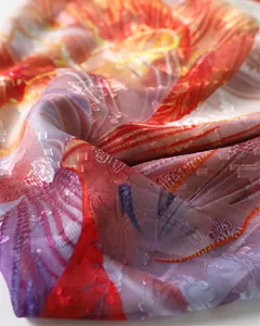 Colorful peacock print sheared silk scarf detail showing soft fabric texture and elegant shawl.