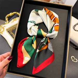 Elegant silk square scarf featuring classic equestrian saddle and strap print design detail.