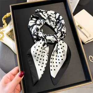 Detailed view of a chic black and white rose and polka dot silk square scarf for women.