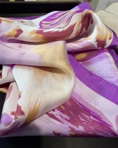 Elegant pink and purple abstract floral print silk scarf detail, chic fashion accessory.