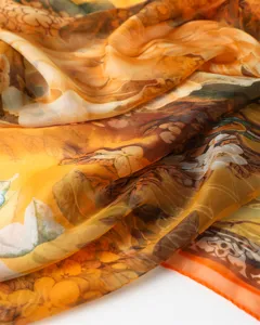 Detailed view of women's orange floral print silk scarf, lightweight summer sun shawl.