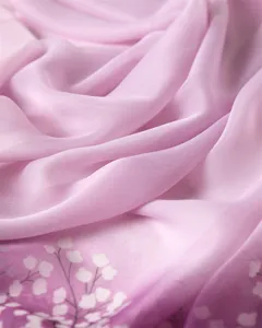 Close-up view of soft pink gradient chiffon scarf featuring delicate floral print detail.