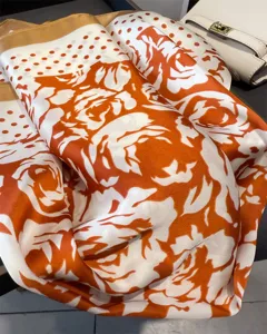 Elegant orange and white silk square scarf featuring rose floral and polka dot patterns for women.