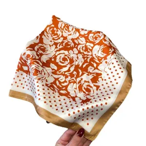 Orange floral silk square scarf main view showing elegant rose print and classic polka dot border.