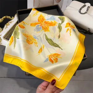 Elegant floral print silk square scarf, vibrant yellow border versatile fashion neck wrap.